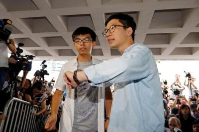 Student leaders Joshua Wong and Nathan Law arrive at the High Court to face verdict on charges relating to the 2014 pro-democracy Umbrella Movement, also known as Occupy Central protests, in Hong Kong, China August 17, 2017. Credit: Reuters