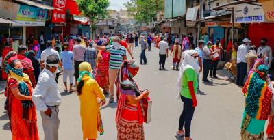  People maintain social distance as they stand in a queue at a wholesale market after authorities allowed shops to open with certain restrictions, during the ongoing COVID-19 nationwide lockdown, in Ahmedabad. Photo: PTI
