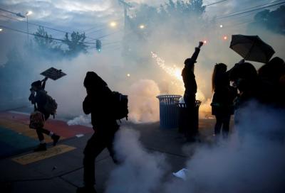 Protesters disperse as tear gas, pepper spray and flash-bang devices are deployed by Seattle police during a protest against police brutality and the death in Minneapolis police custody of George Floyd, in Seattle, Washington, US June 1, 2020. Photo: Reuters/Lindsey Wasson/File Photo