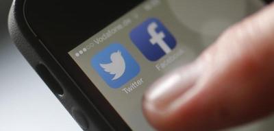 An illustration picture shows a man starting his Twitter App on a mobile device. Photo: Reuters/Kai Pfaffenbach