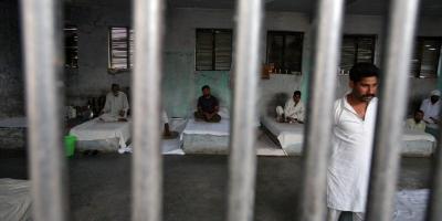 File photo of inmates resting behind bars in a barrack at Kotbhalwal central jail in Jammu, May 18, 2011. Photo: Reuters/Mukesh Gupta