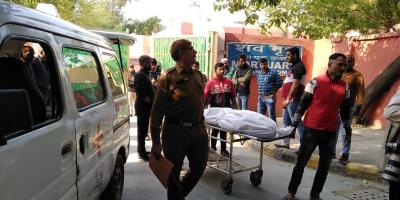 A body being taken home by family members at the GTB hospital near Shahdara on Wednesday. Photo: Dheeraj Mishra