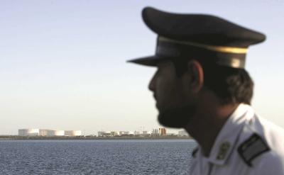 An Iranian guard looks on at oil docks at the port of Kalantari in the city of Chabahar, 300km (186 miles) east of the Strait of Hormuz. Photo: 
Reuters