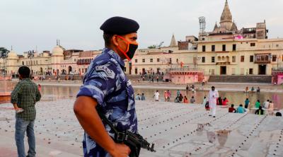 An armed police officer stands guard on the bank of Sarayu river ahead of the foundation-laying ceremony for a Hindu temple in Ayodhya, India, August 4, 2019. Photo: Reuters/Pawan Kumar