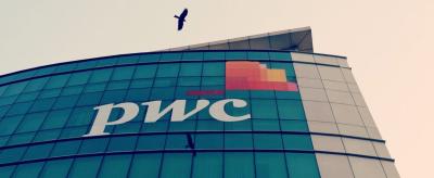 A bird flies past the logo of Price Waterhouse installed on the facade of its office in Mumbai, India, January 11, 2018. Photo: Reuters/Danish Siddiqui