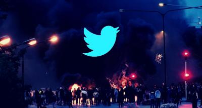 Illustration: The Wire. The Twitter logo in the foreground. In the background, smoke billows during a riot in Malmo, Sweden, on August 28, 2020. Photo: Reuters