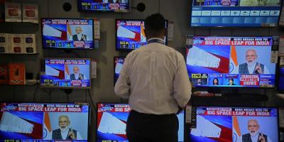 A salesman watches Prime Minister Narendra Modi addressing to the nation, on TV screens inside a showroom in Mumbai, March 27, 2019. Credit: Reuters/Francis Mascarenhas