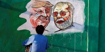 A man works on a painting of Donald Trump and Narendra Modi in Ahmedabad. Photo: Amit Dave/Reuters
