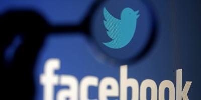 A logo of Twitter is pictured next to the logo of Facebook in this illustration. Photo: REUTERS/Dado Ruvic