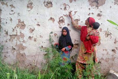 File photo of villagers looking at splinter marks at a house after the ceasefire violation by Pakistan at Shahpur sector near Line of Control in Poonch District. Photo: PTI 