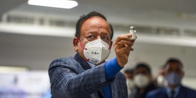 File image of Union Health Minister Harsh Vardhan displaying a Covishield vaccine vial,  
in January 2021. Photo: PTI/Vijay Verma)