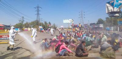 The report makes no mention of this infamous incident from March 30, 2020, when healthcare workers, in protective suits, used a hosepipe to spray disinfectant on migrant workers before allowing them to enter the town of Bareilly.  Photo: PTI