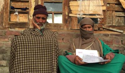 Hameeda Bano, mother of Tabasum Maqbool shows medical reports of her recent surgery in an effort to prove that Maqbool did not perpetrate crimes that J&K police have held her for but was instead caring for her at home. Photo: Kaisar Andrabi.
