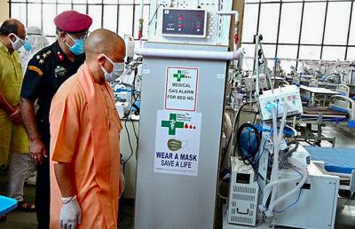 UP CM Yogi Adityanath visits a COVID-19 hospital prepared by DRDO, at Shilpgram in Lucknow, Wednesday, May 5, 2021. Photo: PTI