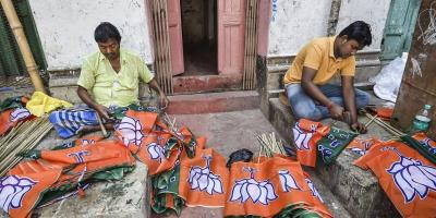 Workers prepare flags of the BJP. Photo: PTI/Ashok Bhaumik