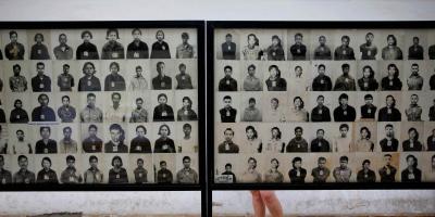 A visitor looks at pictures of victims of Khmer Rouge regime at the former notorious Tuol Sleng prison that is now the Genocide Museum, in Phnom Penh August 5, 2014. Photo: Reuters/Damir Sagol