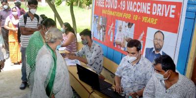 People stand in a queue to receive a COVID-19 vaccine dose at a centre, in Guwahati, July 23, 2021. Photo: PTI