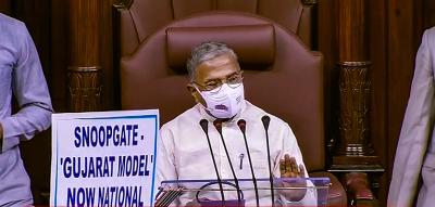 Protesting opposition MPs hoist a placard in front of Rajya Sabha deputy chairman Harivansh Narayan Singh during the Monsoon Session of parliament, New Delhi, July 27, 2021. Photo: RSTV/PTI Photo