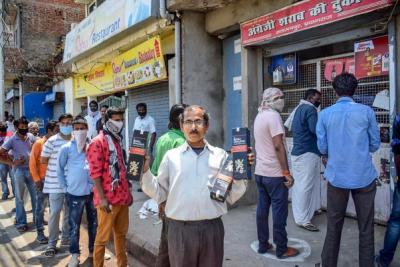 Representative image. People purchase alcohol from a wine shop after authorities allowed sale of liquor with certain restrictions, during the ongoing Covid-19 nationwide lockdown. Photo: PTI
