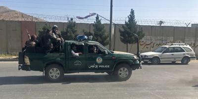 Taliban fighters ride on a police vehicle in Kabul, Afghanistan, August 16, 2021. Photo: Reuters/Stringer