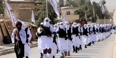 Taliban fighters march in uniforms on the street in Qalat, Zabul Province, Afghanistan, in this still image taken from social media video uploaded August 19, 2021 and obtained by Reuters
