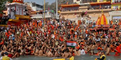 Hindu devotees take a holy dip in the Ganges River during Shahi Snan at 