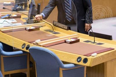 A conference officer adjusts the microphone ahead of the Security Council meeting on the situation in Afghanistan. Photo: UN Photo/Manuel Elías