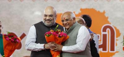 Union Home Minister Amit Shah congratulates the new Chief Minister of Gujarat Bhupendra Patel during a swearing-in ceremony at Raj Bhavan in Gandhinagar, Monday, September 13, 2021. Photo: PTI