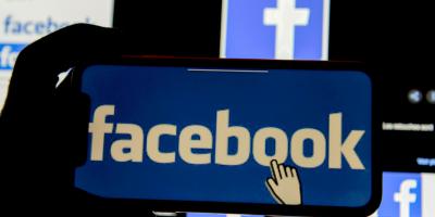 The Facebook logo is displayed on a mobile phone in this picture illustration taken December 2, 2019. Photo: Reuters/Johanna Geron/Illustration