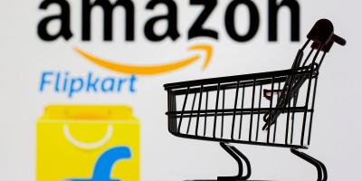 A toy shopping cart is seen in front of Amazon and Flipkart logos in this picture illustration. Photo: Reuters/Dado Ruvic/Illustration