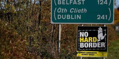 A 'No Hard Border' poster is seen below a road sign on the Irish side of the border between Ireland and Northern Ireland near Bridgend, Ireland October 16, 2019. Photo: Reuters/Phil Noble