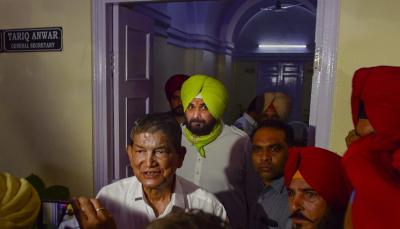 New Delhi: Punjab Pradesh Congress Committee chief Navjot Singh Sidhu with Congress's Punjab in-charge Harish Rawat after a meeting in New Delhi, Thursday, Oct. 14, 2021. Photo: PTI