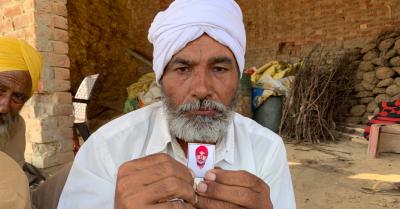 A farmer holds the photo of his brother, Gurpreet Singh, who took his own life after his cotton crops were devastated in Moosa village of Mansa district in Punjab.  Photo: Prabhjit Singh