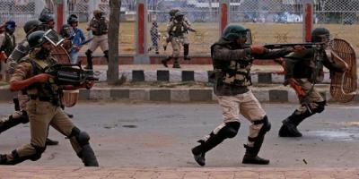 A policeman aims a gun towards protesters in Srinagar. Representative image. Photo: Reuters/Danish Ismail
