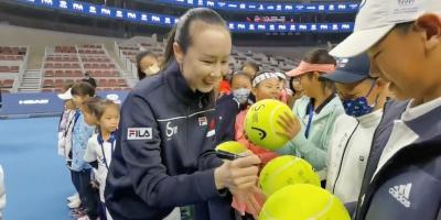 Chinese tennis player Peng Shuai signs large-sized tennis balls at the opening ceremony of Fila Kids Junior Tennis Challenger Final in Beijing, China November 21, 2021, in this screen grab obtained from a social media video. Photo: via Reuters