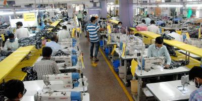 Workers at an apparel manufacturing company in Noida during the COVID-19-induced lockdown. Photo: PTI