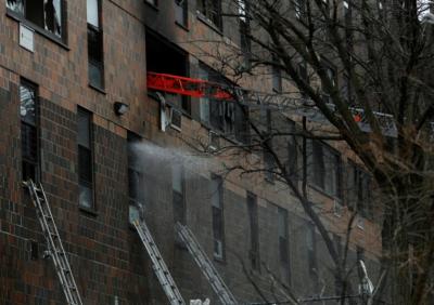 Emergency personnel from the FDNY respond to an apartment building fire in the Bronx borough of New York City, U.S., January 9, 2022. Photo: Lloyd Mitchell via Reuters