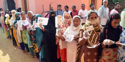 Voters show their identity cards before casting their respective votes at a polling station, during Tarapur assembly by-polls, in Munger district, October 30, 2021. Photo: PTI