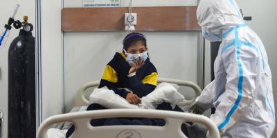 A COVID-19 infected patient rests on her bed inside a Covid care centre of the Commonwealth Games (CWG) village, in New Delhi, Tuesday, Jan. 4, 2022. Photo: PTI/Kamal Singh