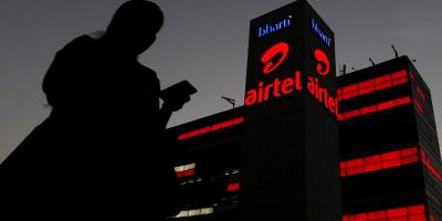 File Photo: A girl checks her mobile phone as she walks past the Bharti Airtel office building in Gurugram, previously known as Gurgaon, on the outskirts of New Delhi, India April 21, 2016. Photo: Reuters/Adnan Abidi/File Photo/File Photo
