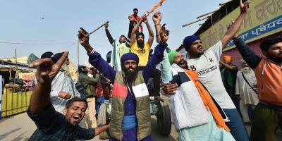 Farmers celebrate after Prime Minister Narendra Modi announced the repealing of the three Central farm laws, at Singhu Border in New Delhi, Friday, Nov. 19, 2021. Photo: PTI