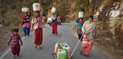 Women in search of drinking water report extensive drying of khulgaads and other mountain streams in the forests in Pauri. Photo: Kumar M. Tiku