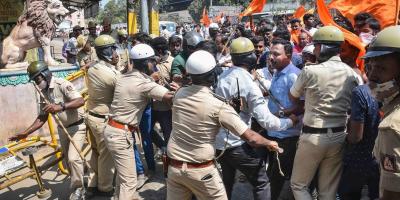 Police personnel attempt to maintain law and order as rioters pelt stones, amid tension over the murder of a member of Bajrang Dal on Sunday night, in Shivamogga, Monday, Feb. 21, 2022. Photo: PTI. 