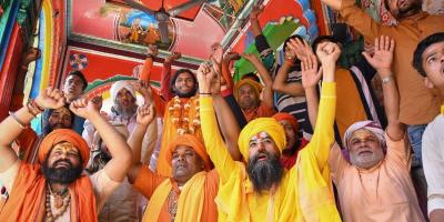 Sadhus celebrate as BJP leads, during counting day of Uttar Pradesh Assembly elections, in Ayodhya district, Thursday, March 10, 2022. Photo: PTI