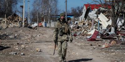 A Ukrainian service member walks, as the Russian invasion continues, in a destroyed village on the front line in the east Kyiv region, Ukraine March 21, 2022. Photo: Reuters/Gleb Garanich