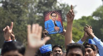 Members of Dalit community display a portrait of BR Ambedkar during a 'Bharat Bandh' over the 'dilution' of SC/ ST act. Photo: PTI