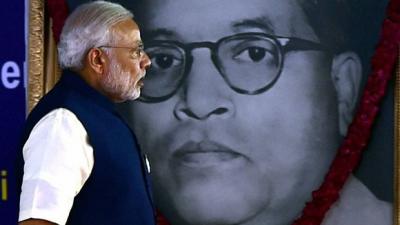 Prime Minister Narendra Modi walks past an image of Dr B.R. Ambedkar. Photo: PTI/Files