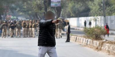 The shooter brandishes a gun outside the Jamia Millia Islamia university in New Delhi, India, January 30, 2020. His face has been blurred as he was a minor at the time. Photo: Reuters/Danish Siddiqui