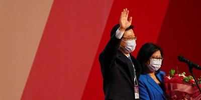 John Lee waves next to his wife Janet Lam Lai-sim after being elected as Hong Kong's Chief Executive, in Hong Kong, China, May 8, 2022. REUTERS/Lam Yik