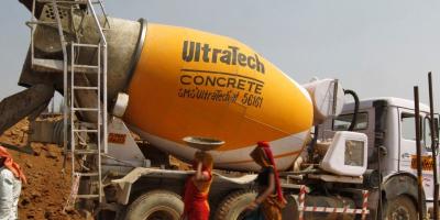 Representational image. Workers walk in front of an UltraTech concrete mixture truck at the construction site of a commercial complex on the outskirts of the western Indian city of Ahmedabad April 22, 2013. Photo: Reuters/Amit Dave
